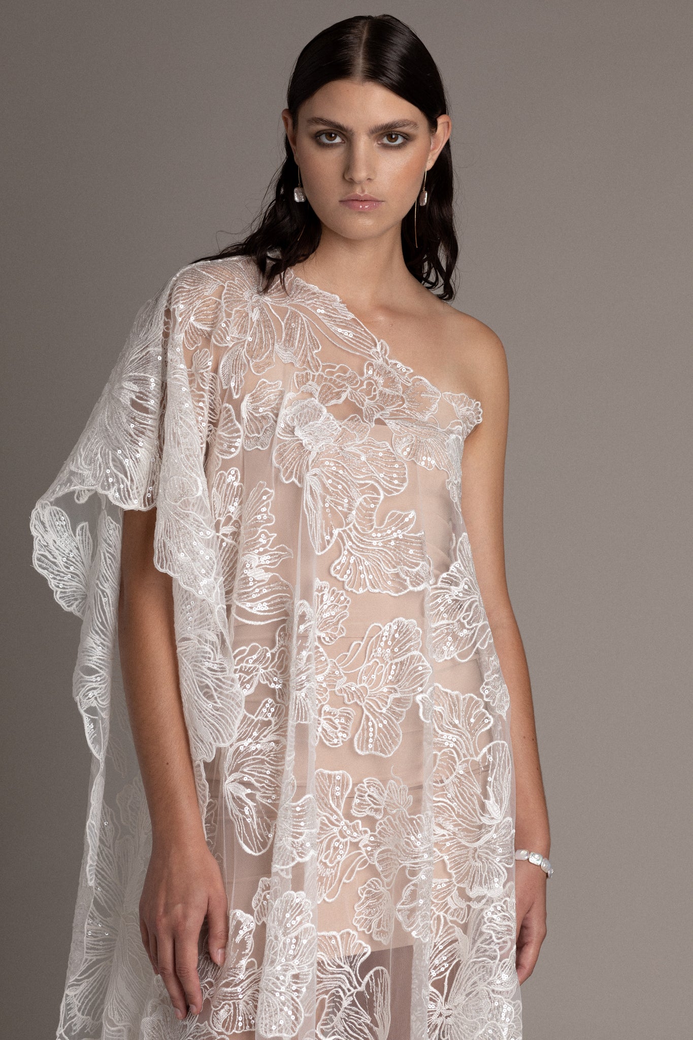 Asymmetric Couture Dress is meticulously crafted for the woman who seeks to make a statement on her wedding day. The asymmetric silhouette creates an artful balance between sophistication and daring.