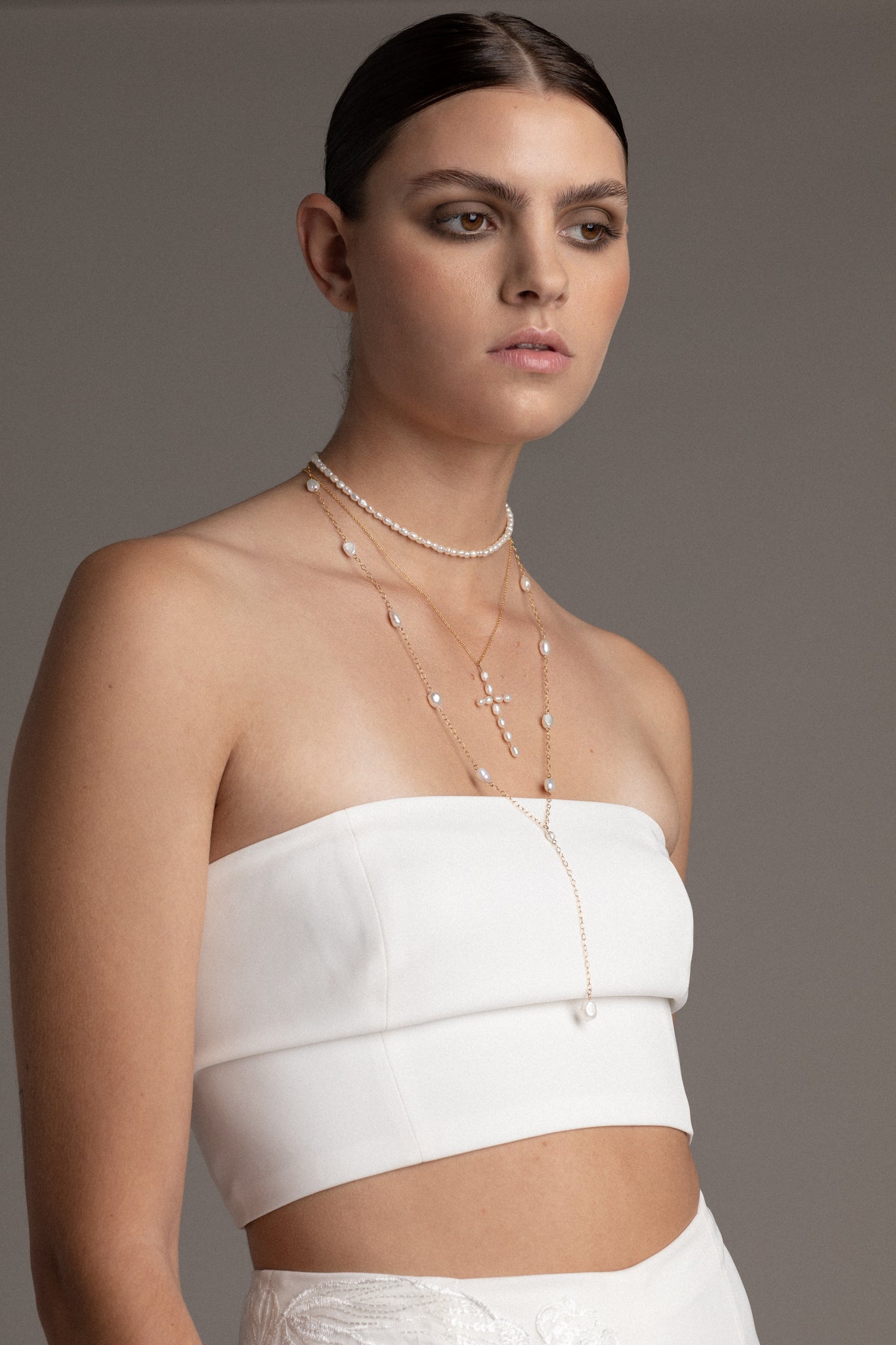 Pearl Cross Necklace – a fusion of classic elegance and symbolic beauty. This necklace showcases a delicate cross pendant adorned with lustrous freshwater pearls.