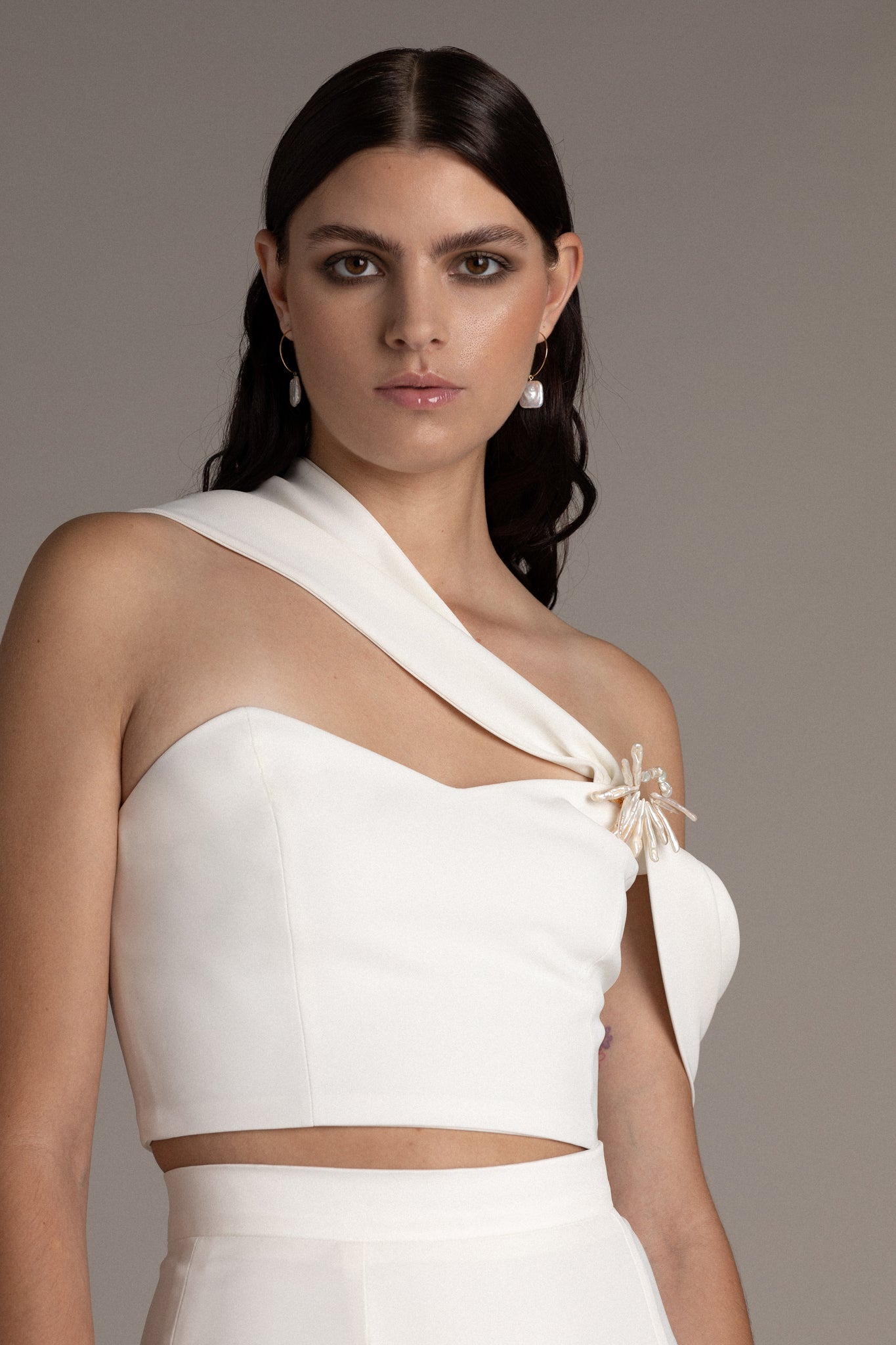 Structured Asymmetric Bodice is a statement piece that commands attention when paired with pants or a skirt. The asymmetric shoulder details create a captivating drape that enhances your silhouette.