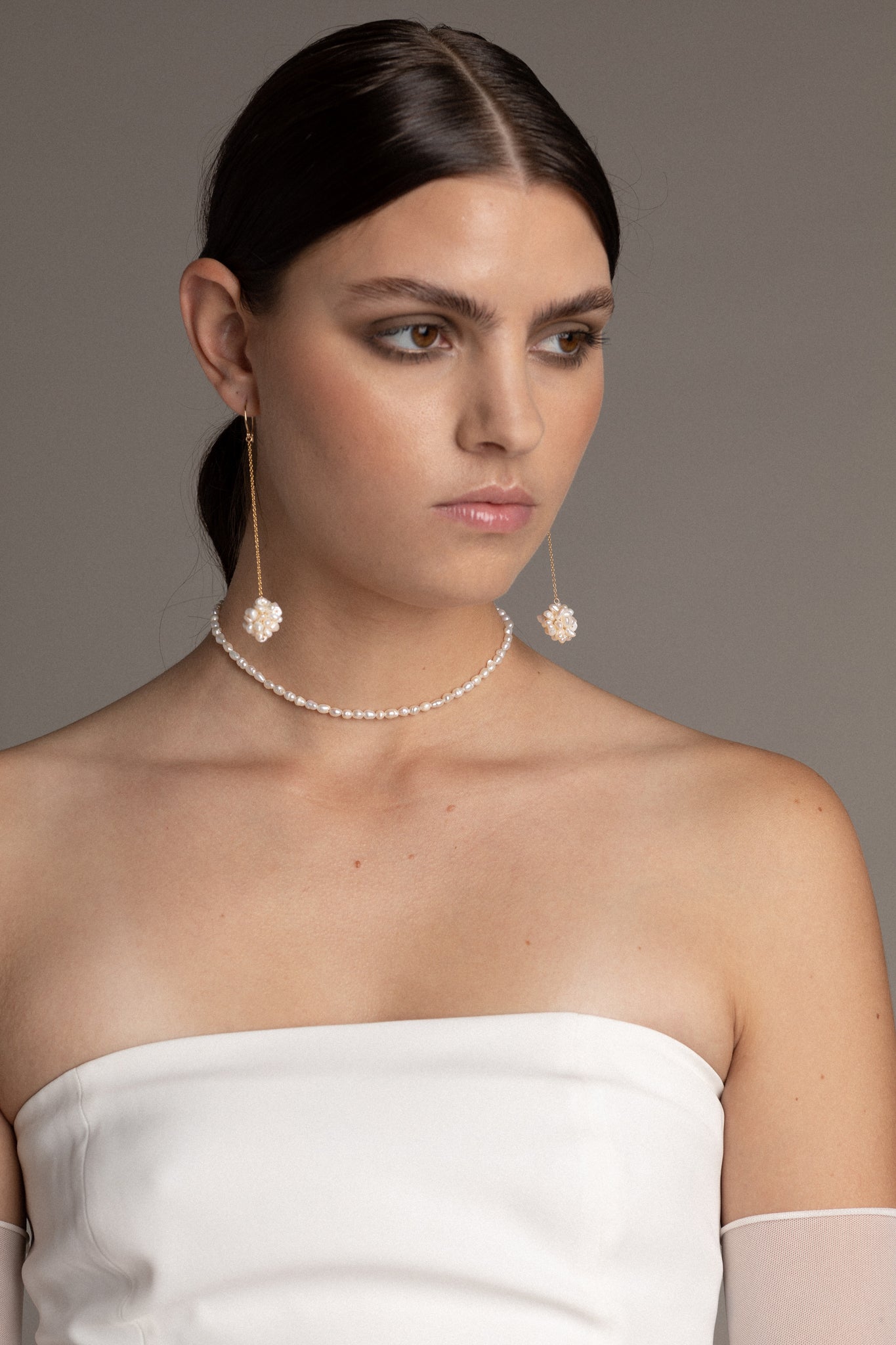 This choker showcases petite, irregular freshwater pearls strung on a wire, creating a distinctive and captivating look. P