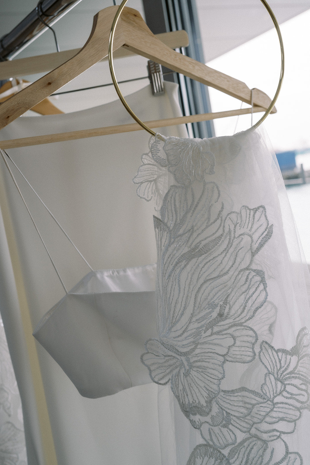 Bridal veils are hanging on a rack at TEMPÊTE Vancouver bridal boutique