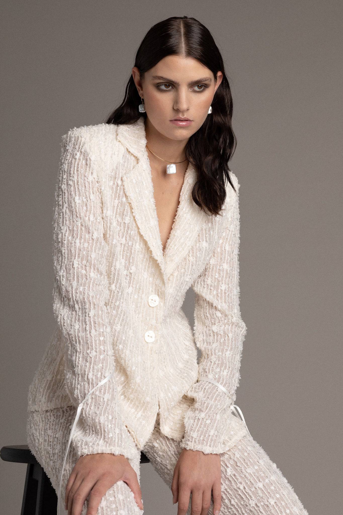 Model is wearing a blazer and a pant set by TEMPÊTE