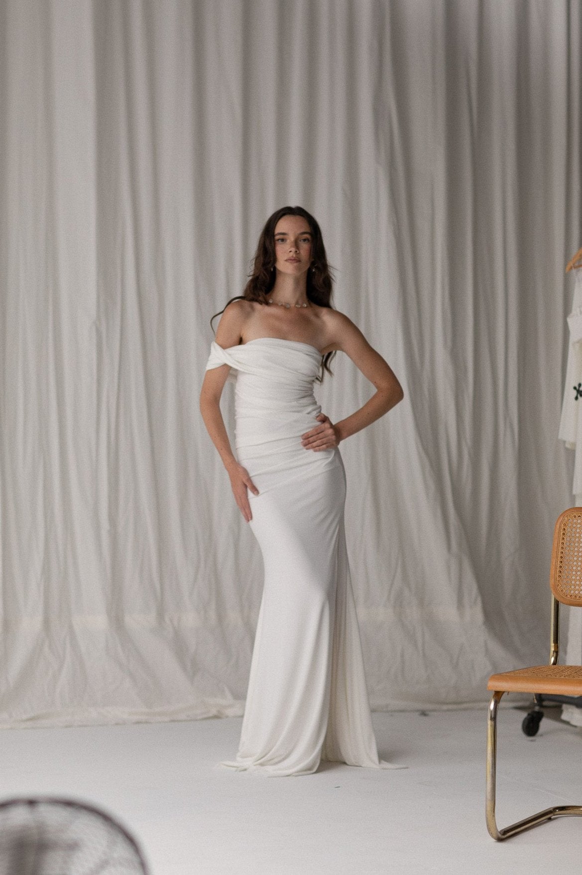 Bride in a draped knit slit skirt from TEMPÊTE, showcasing a fitted silhouette with a stylish slit, ideal for a bold and contemporary bridal outfit