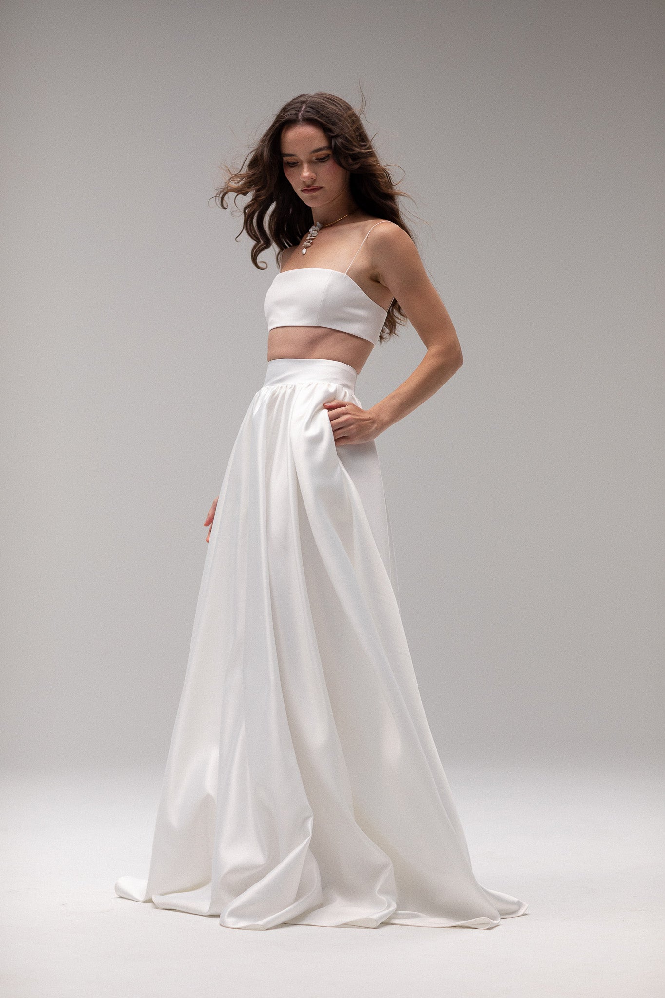 Detailed view of a high-waisted satin gathered maxi skirt by TEMPÊTE, offering an elegant and modern fit, perfect for creating a stunning wedding day outfit