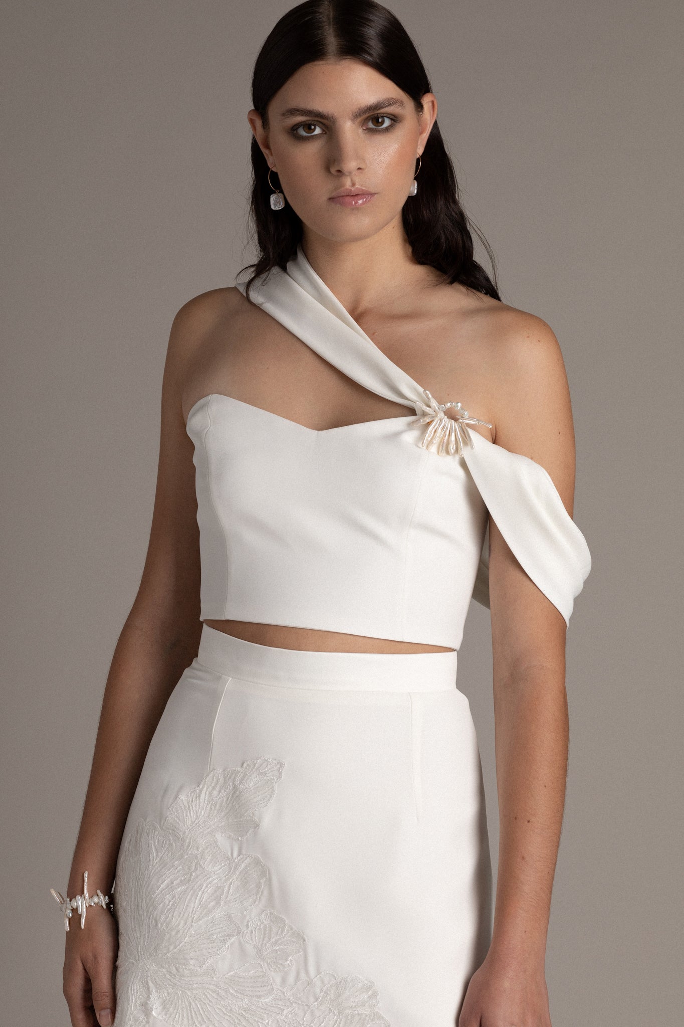 Structured Asymmetric Bodice is a statement piece that commands attention when paired with pants or a skirt. The asymmetric shoulder details create a captivating drape that enhances your silhouette.