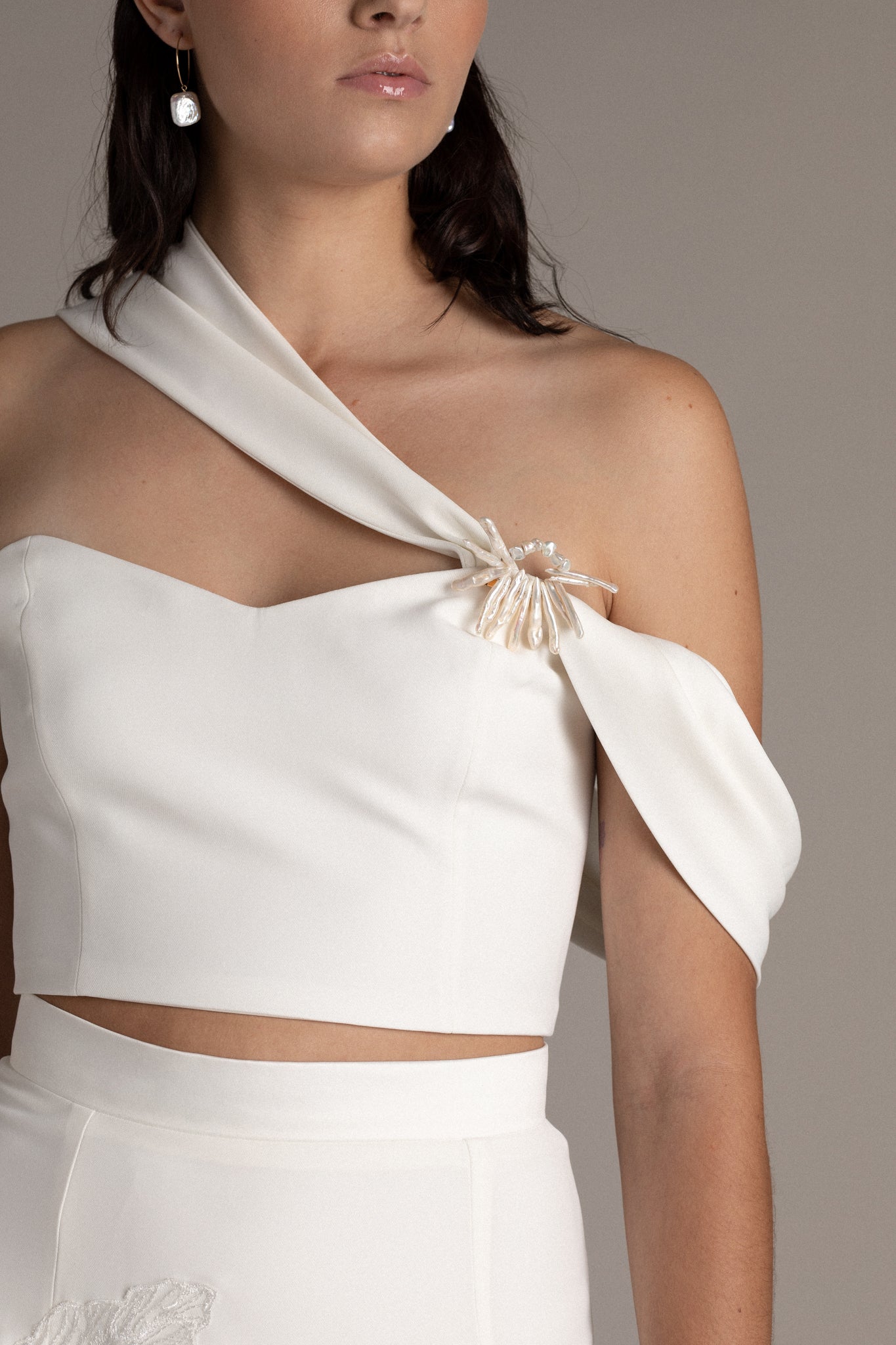 Structured Asymmetric Bodice is a statement piece that commands attention when paired with pants or a skirt. The asymmetric shoulder details create a captivating drape that enhances your silhouette.
