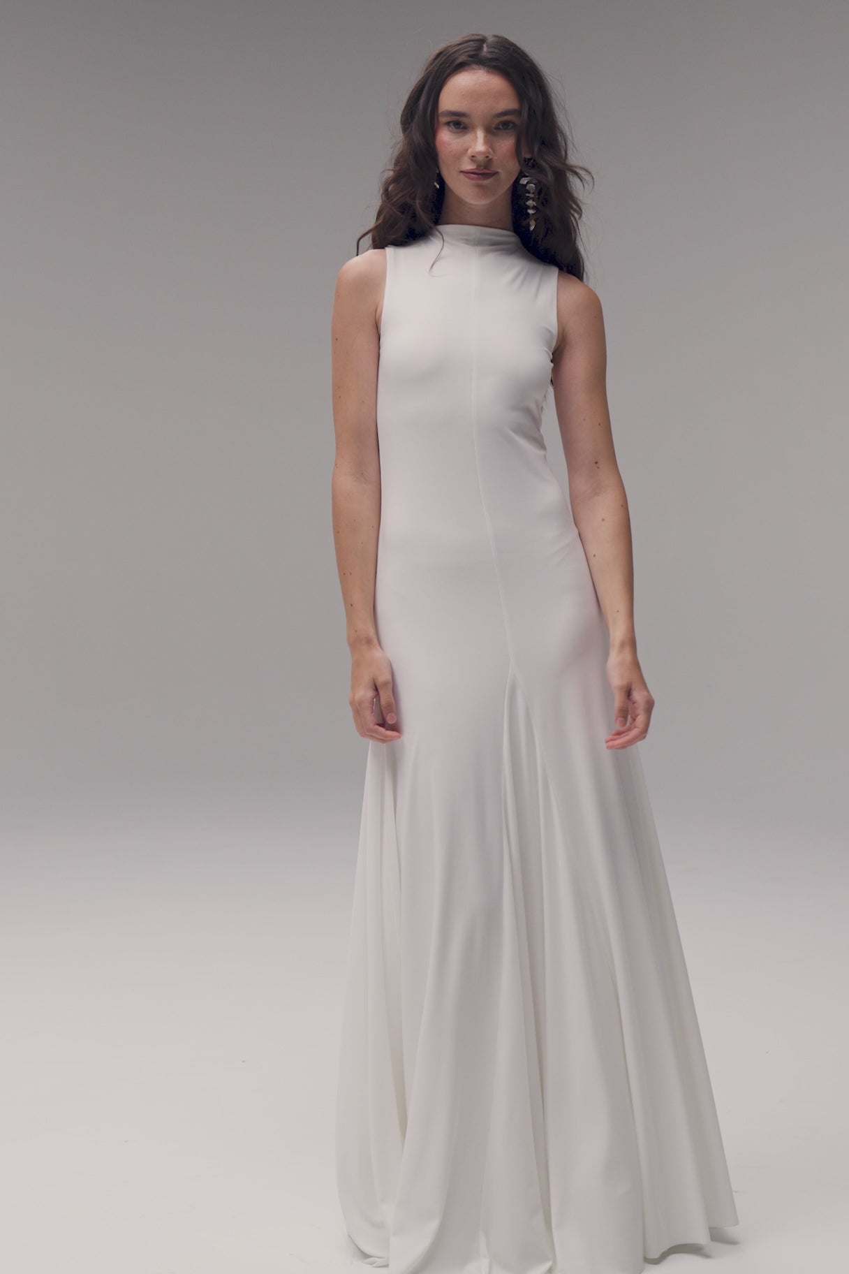 Bride in TEMPÊTE’s high neck knit dress, showcasing a form-fitting design with a voluminous bottom.