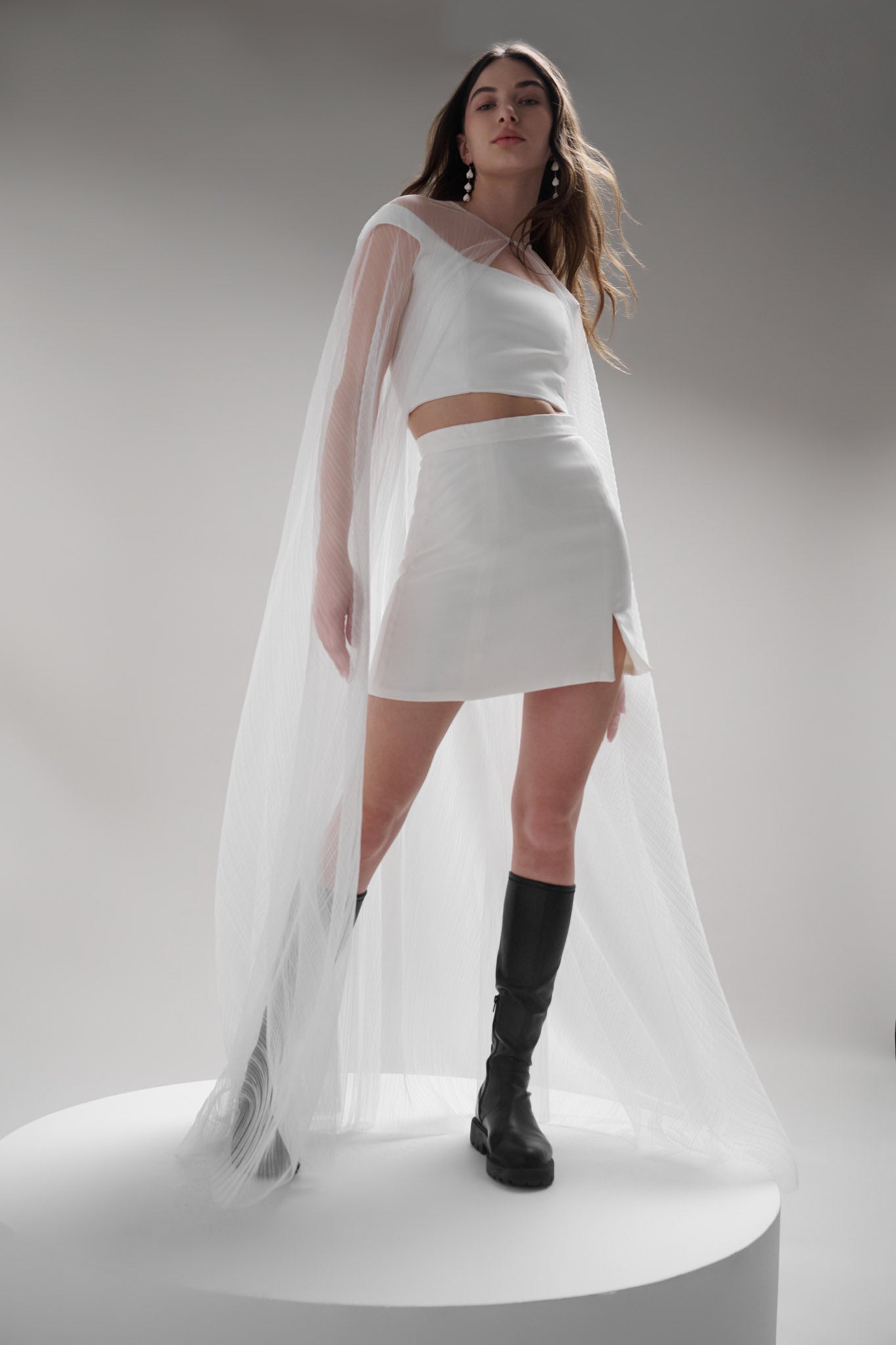 Coquille Cape - a modern veil alternative made with translucent tulle that adds ethereal beauty to any look. Featuring a hidden hook and eye closure for easy removal and showcasing the details underneath, this accessory is an effortless two-in-one outfit