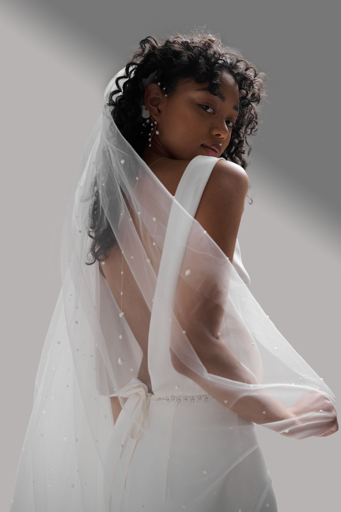 Mesmerizing pearl wedding veil with lustrous pearls speckled throughout fine tulle