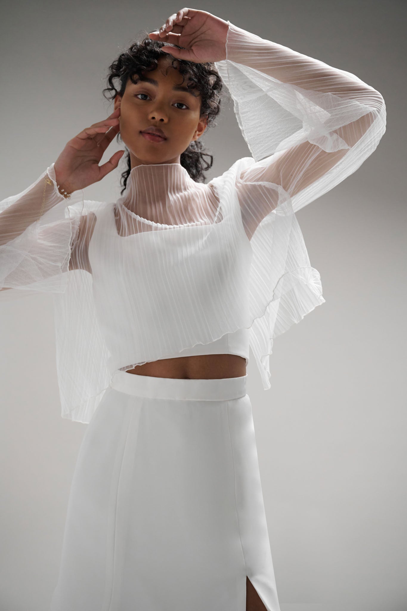 A textured fabric with a seashell-inspired design creates a bold and contemporary look in the bridal world. Its unique shape and form make it a versatile choice, perfect for styling with a range of outfits including skirts, pants, tops, or dresses