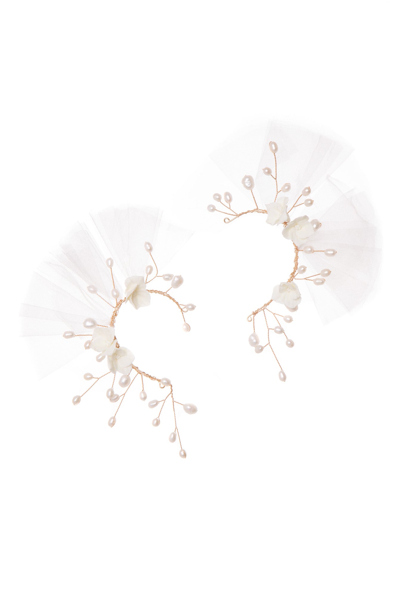 Discover an elegant, fashion-forward look with Cloudburst Cuffs. These delicate ear cuffs feature an intricate floral pattern and pearls, creating a unique yet sophisticated style. 