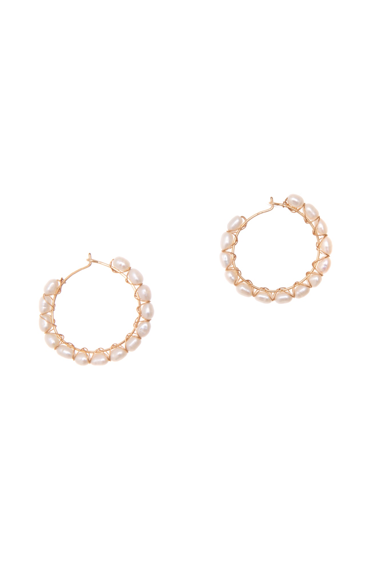 Luxuriate in the elegance of our Halo hoops featuring freshwater pearls strung along 14k gold-filled hoops.